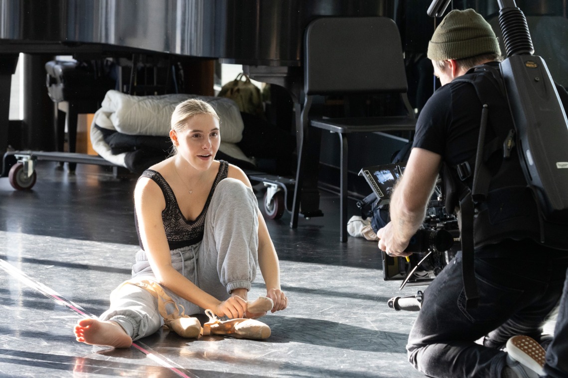 Image of School of Dance sophomore Avery Gay tying shoe and filming for 'So You Think You Can Dance'