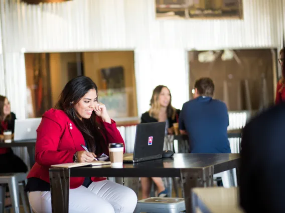 Woman sitting at laptop in cafe