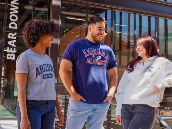 Group of people talking, wearing Wildcat gear
