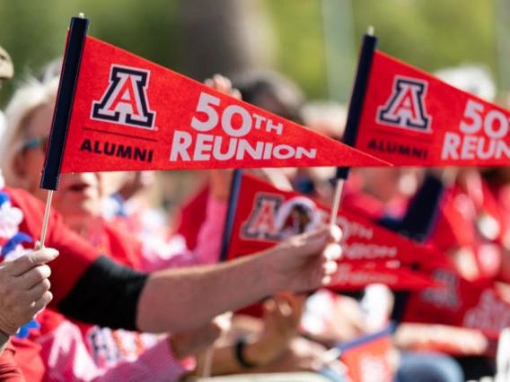 Person holding pennant that says 50th Reunion