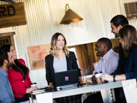 Six people smiling around a table.