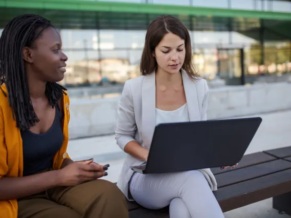Two people working on a laptop