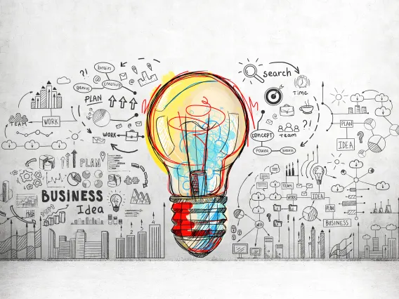 Lightbulb surrounded by business related text and pictures