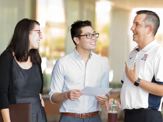 Three people talking with each other.