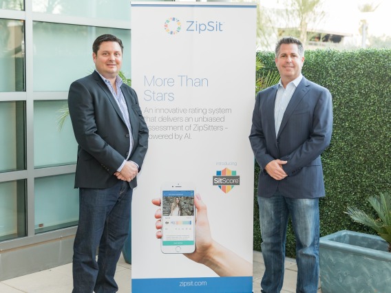 Zipsit founders standing in front of a sign.