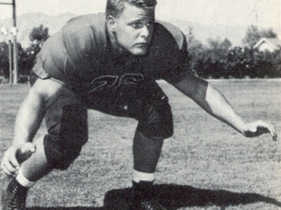 Black and white photo of a football player in the 1950s
