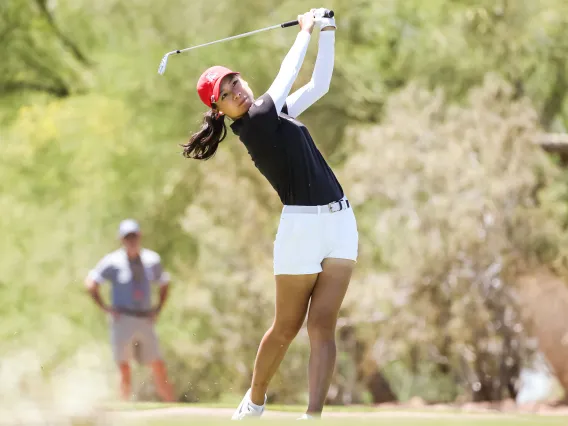 Female golfer swinging club