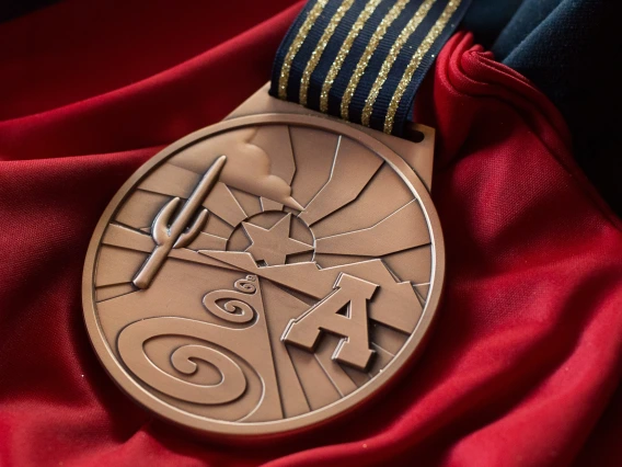 A bronze medal with a Block "A" and a cactus