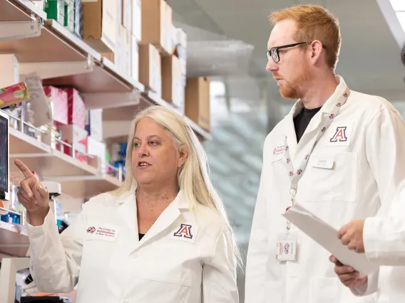 Female researcher talking with two other researchers 