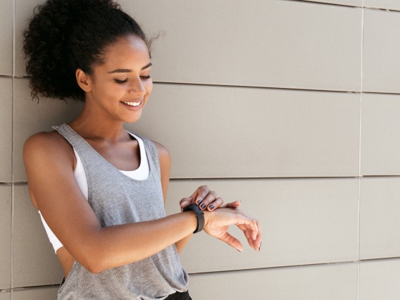 Woman looking at fitness tracker watch