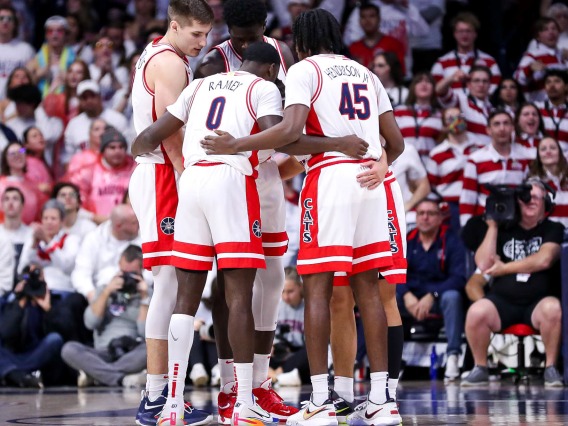 Arizona basketball players huddled together on court