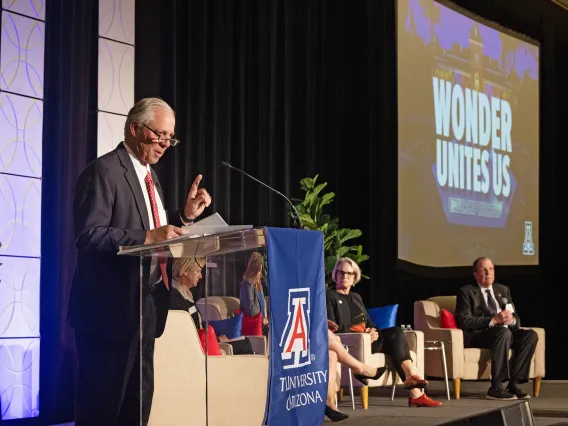 President Robbins speaking at podium