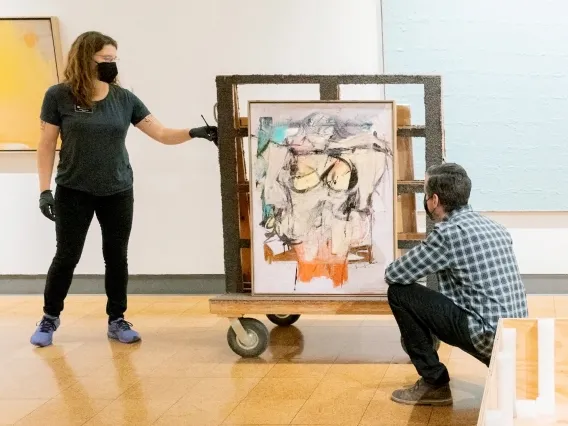 Two workers looking at painting