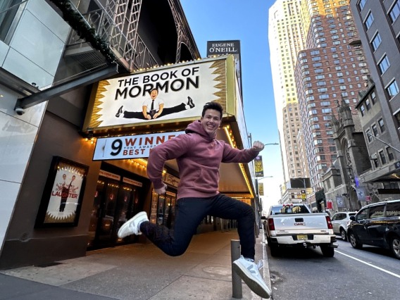 A photograph of Tony Moreno '21 in front of "The Book of Mormon" at the Eugene O'Neill Theatre in New York City.