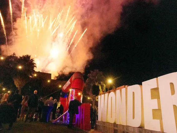 Fireworks display celebrates before large letters on the mall that spell WONDER