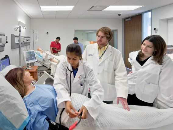 Image of three UArizona students learning and practicing.