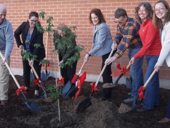 Images of members of the Flandrau Science Center and Planetarium planting the Artmeis I moon tree.