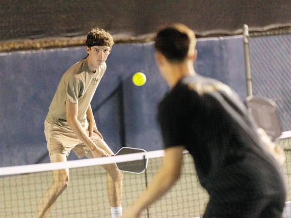 Jake Bejar looking intensely at his competitor while playing pickleball 