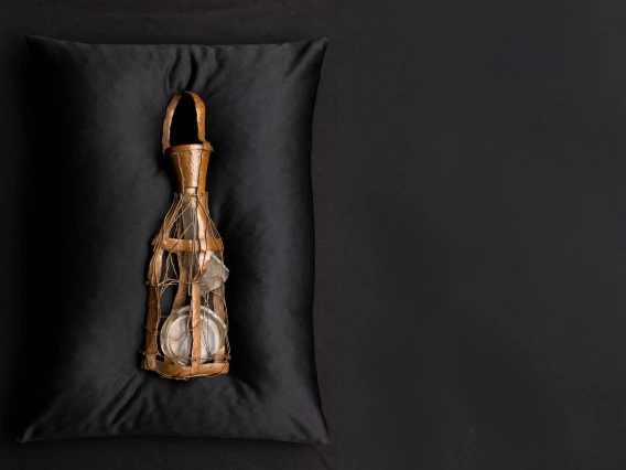 Bottle on black pillow