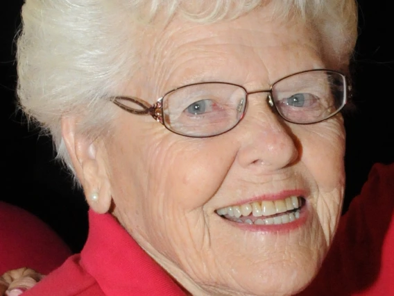 Marilyn smiling, wearing a red polo and a College of Education polo 