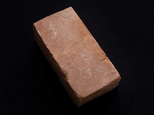 A red brick against a black background
