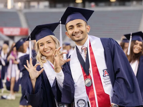 A photograph of two University of Arizona students on Graduation Day. 