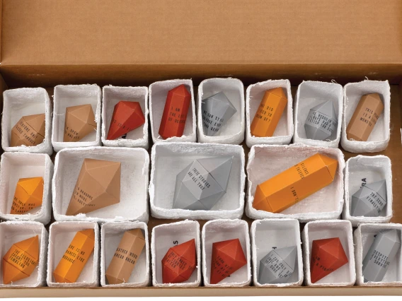 Box containing 21 origami gemstones