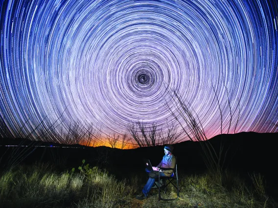 Student camping under the stars