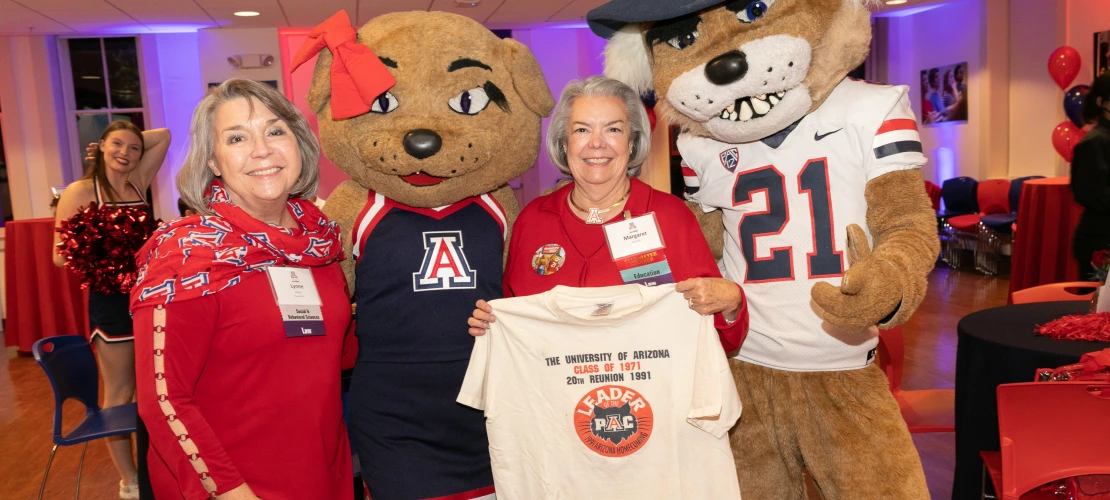 Two reunion attendees with Wilbur and Wilma