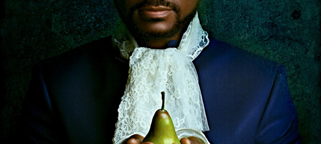 Black man holding pear