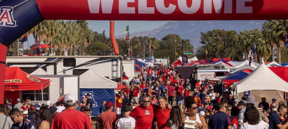 Welcome sign at the Wildcat for Life Tailgate with a large crowd