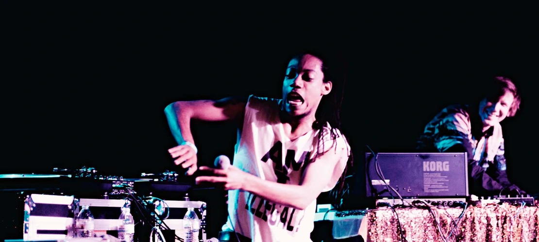 Image of a man performing in front of a crowd.