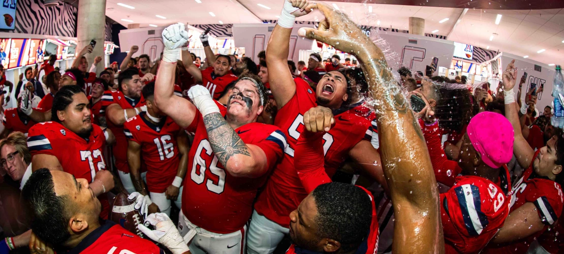 Football players celebrate a win