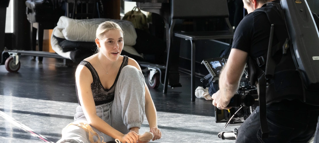 Image of School of Dance sophomore Avery Gay tying shoe and filming for 'So You Think You Can Dance'