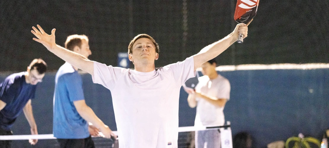 Brandon Tong celebrating with his arms wide on the court