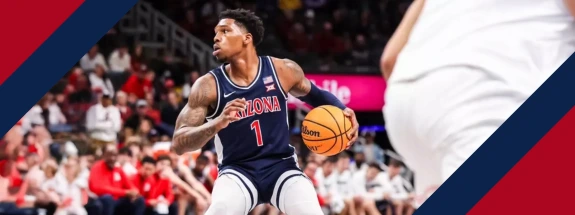 An action shot of Arizona men's basketball player, Caleb Love, with the basketball.