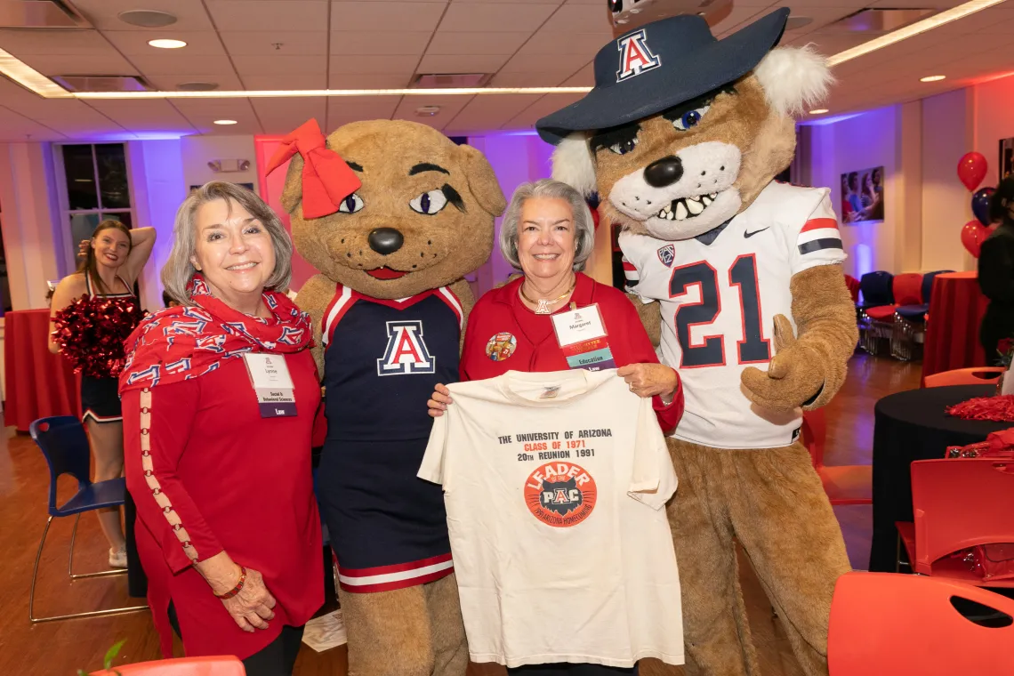 Two reunion attendees with Wilbur and Wilma