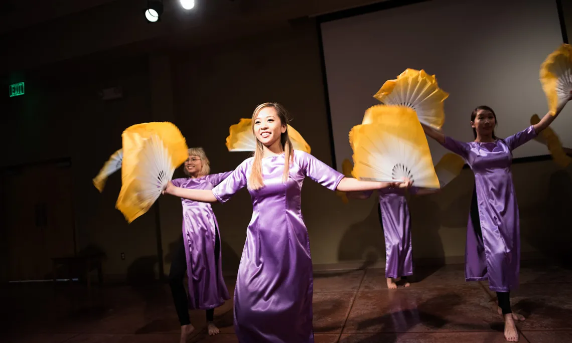 Asian women performing a fan dance