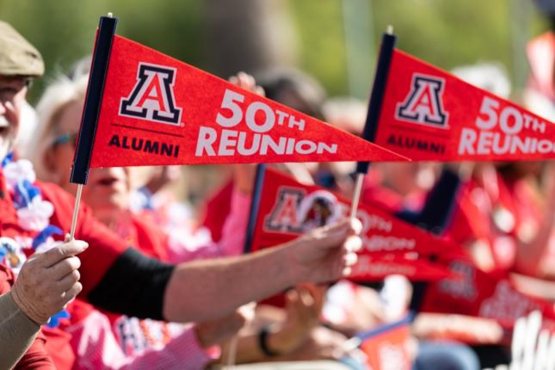 Person holding pennant that says 50th Reunion