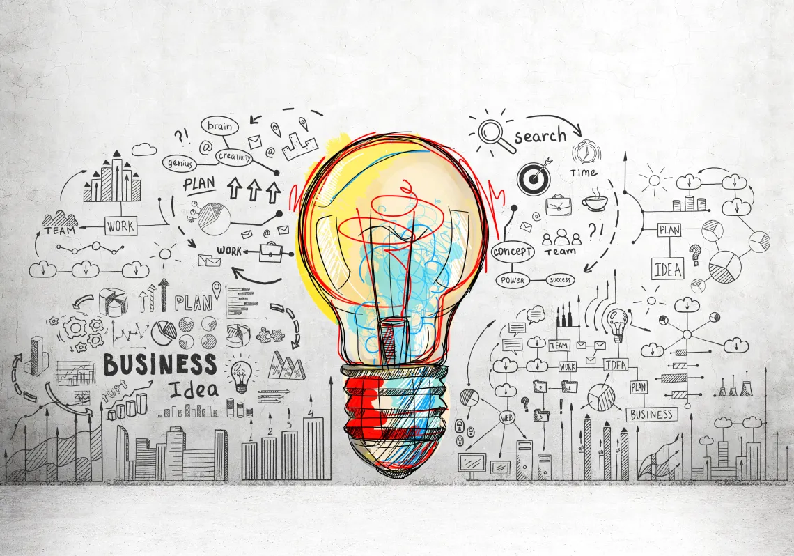 Lightbulb surrounded by business related text and pictures