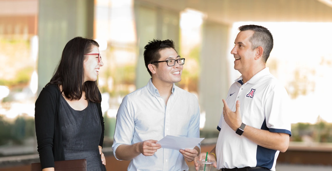 Three people talking with each other.