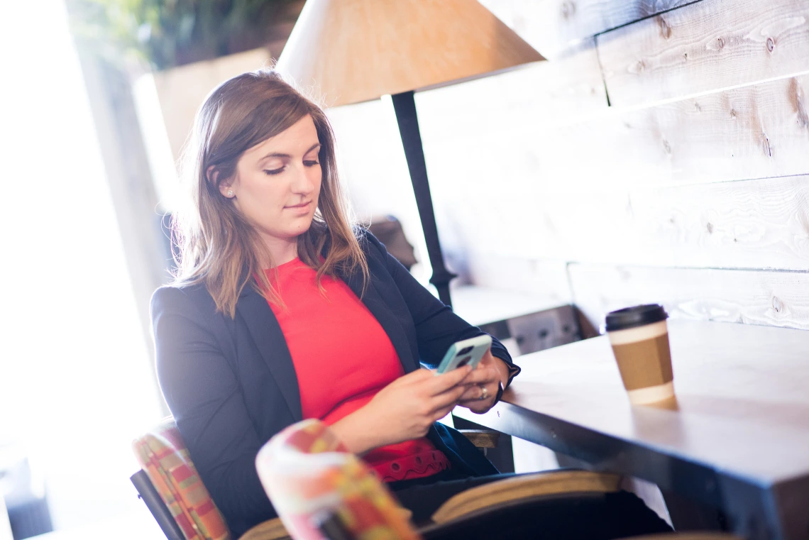 Person on their phone in a coffee shop.