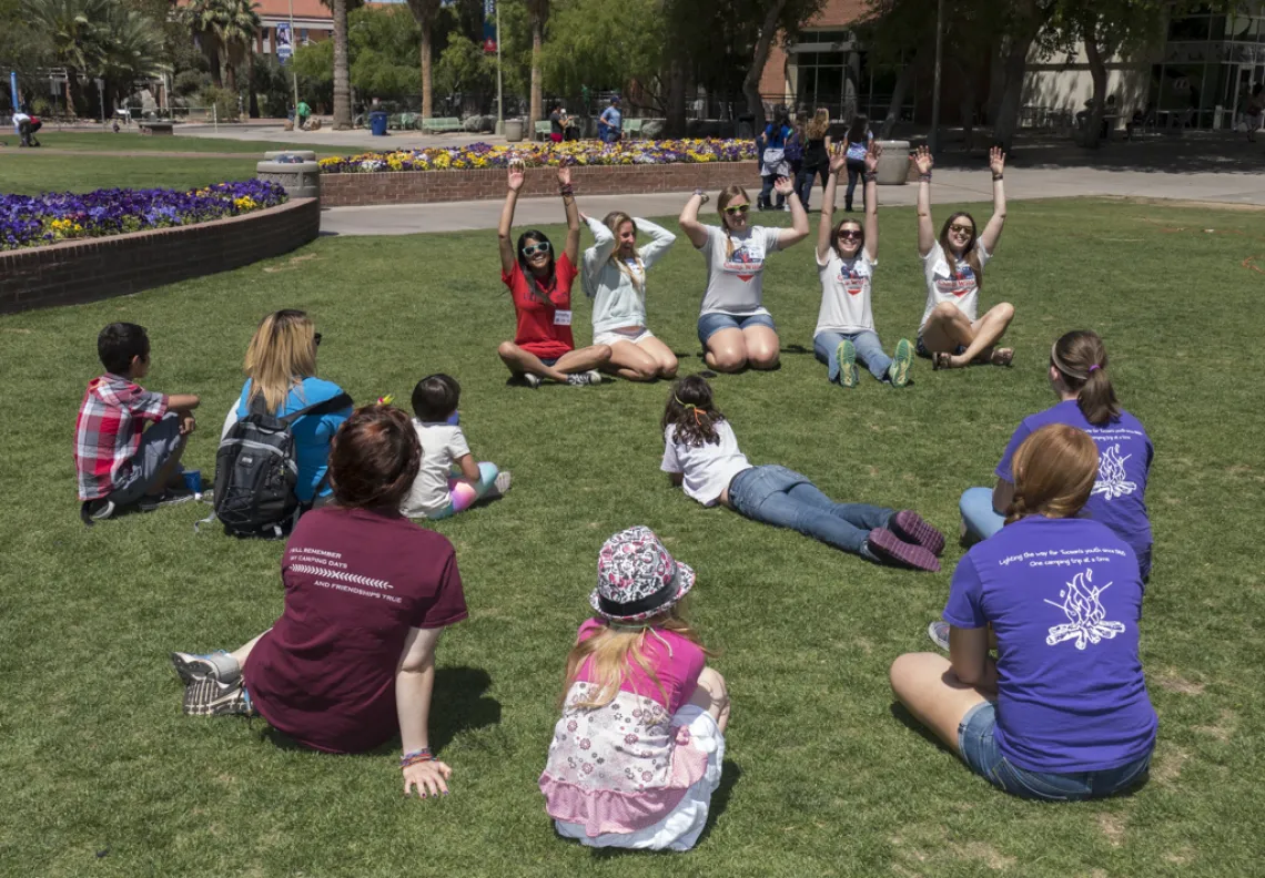 Kids sitting on the grass on the Mall
