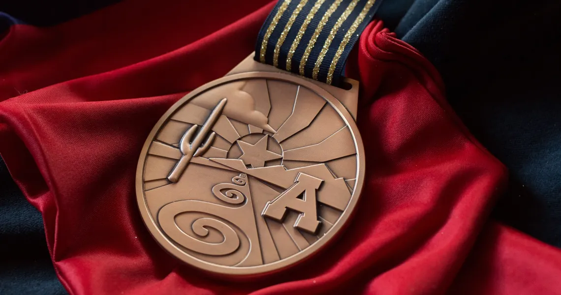 A bronze medal with a Block "A" and a cactus