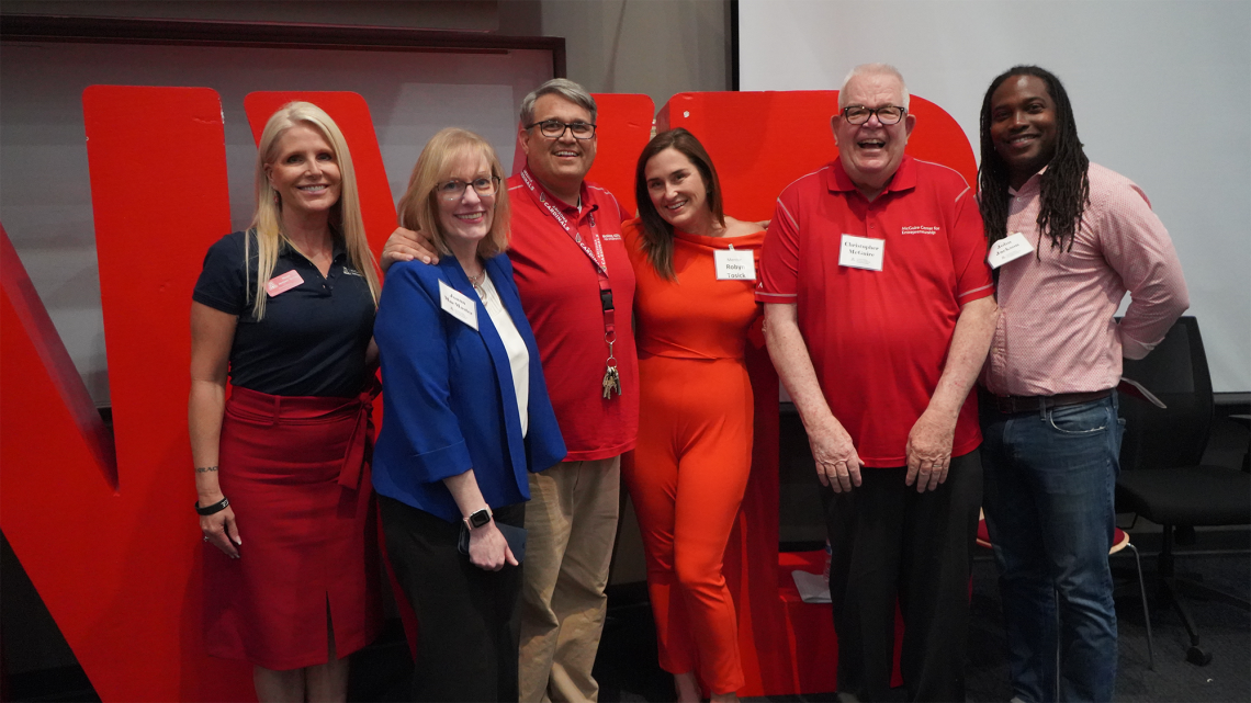 Group of people in red and blue business casual clothes