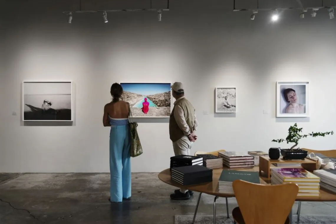 Two people looking at artwork on a wall