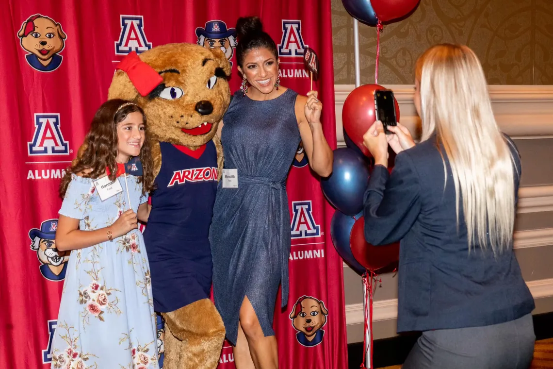 Woman and girl taking photo with Wilma