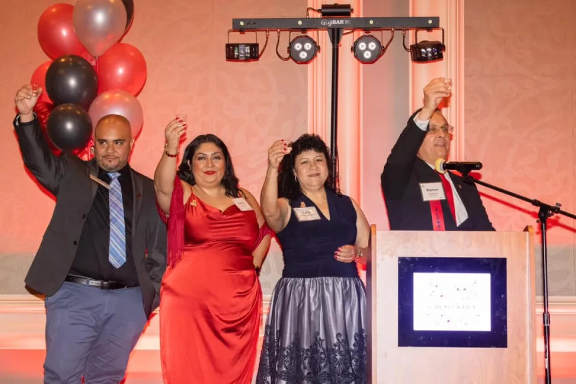 People raising glasses for a tequila toast