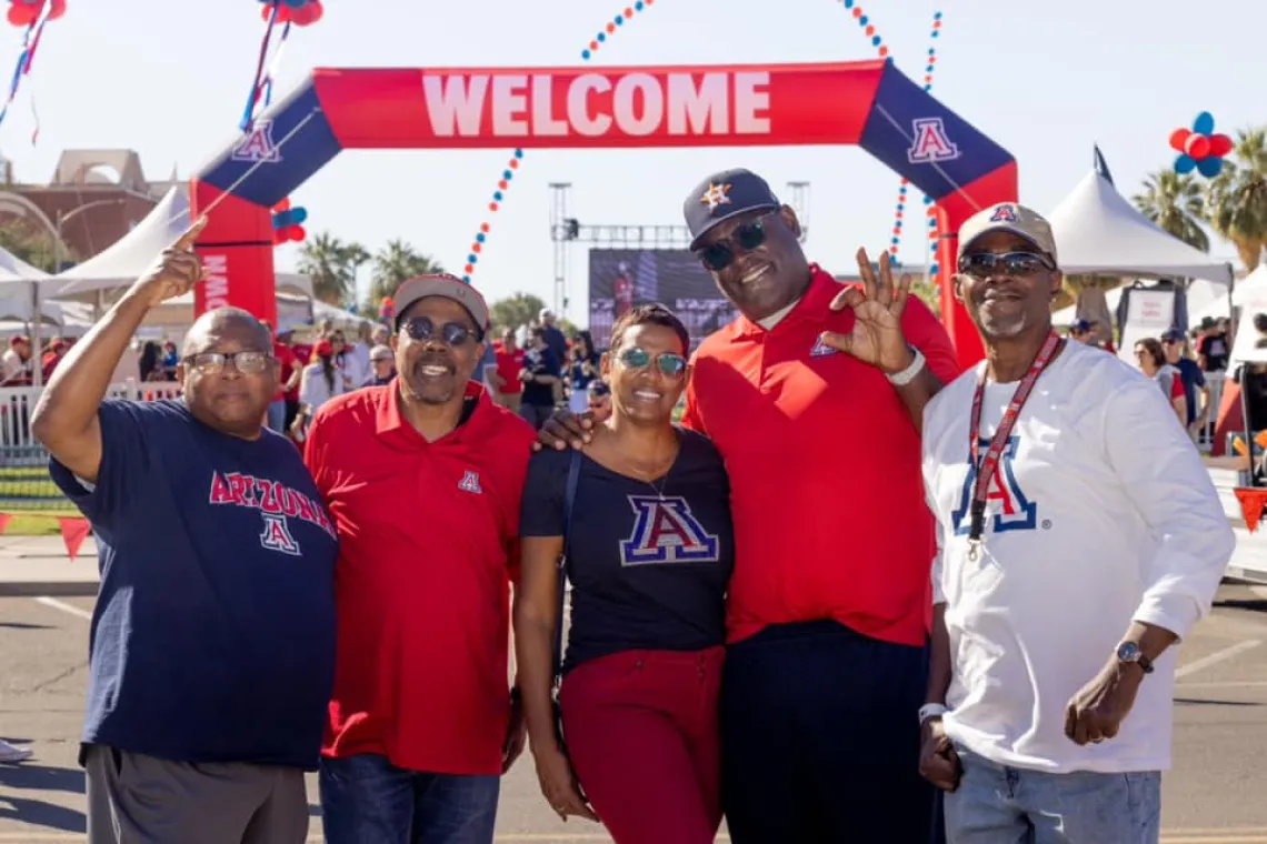 Family in front of welcome sign