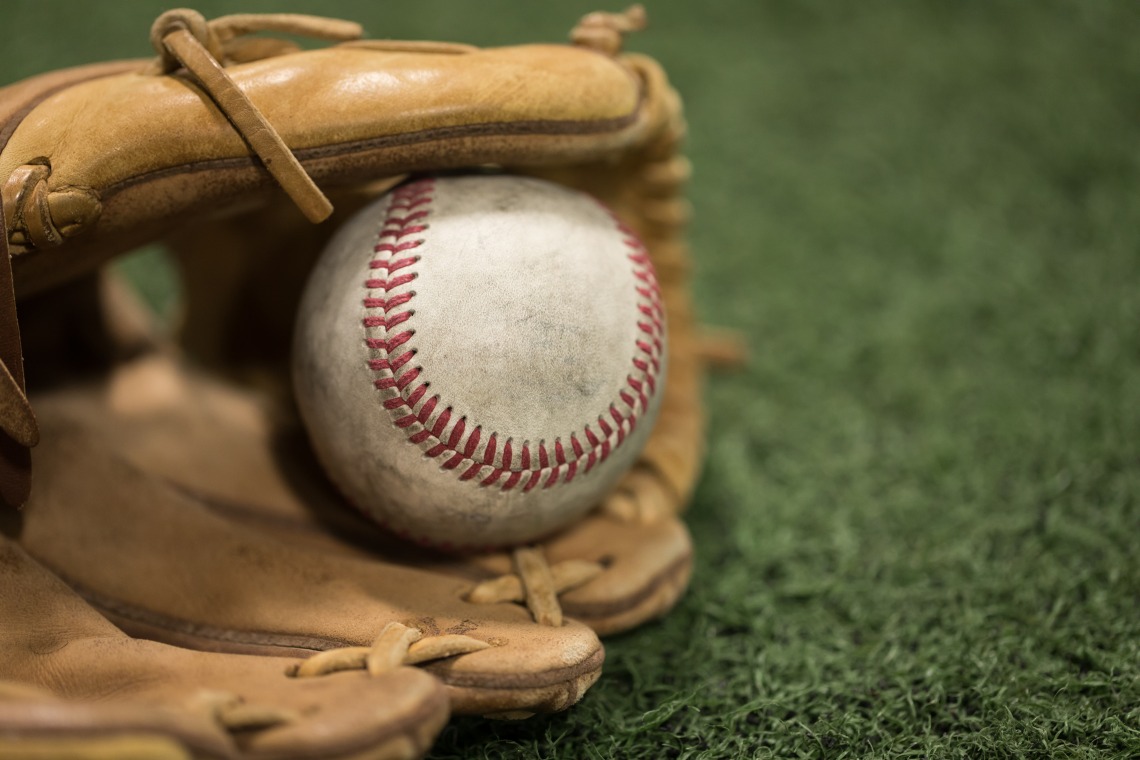 A photograph of a baseball in a mitt